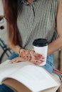 Young woman sipping coffee or tea and reading magazine Royalty Free Stock Photo