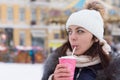 Young woman sipping a hot drink in winter weather Royalty Free Stock Photo