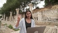 Young woman sit in park communicating by video call. Girl speaking looking at laptop computer, online conference