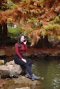 Young woman sit on rock and listening to music with headphones Royalty Free Stock Photo