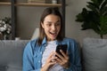 Woman read media news on cellphone looks amazed