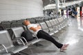 Young woman sits at airport in the waiting room. Flight delay Royalty Free Stock Photo