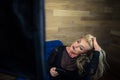 Young woman sits on armchair with soft box light Royalty Free Stock Photo