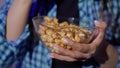 Young woman sits on an armchair and watches TV. Eating popcorn and drinking soda Royalty Free Stock Photo