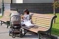 A young woman sits on a bench in the garden