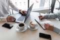 Young woman sits with boss and takes notes in a notebook. Two business people in a cafe at an informal meeting. Teamwork. Royalty Free Stock Photo