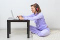 Young woman sits on the floor, listening music Royalty Free Stock Photo