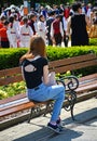 Young woman sits on a park bench