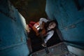 A young woman sits and plays guitar inside of old abandoned ship Royalty Free Stock Photo