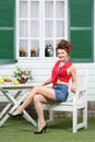 Young woman sits at white wooden table with fruits Royalty Free Stock Photo