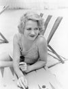 Young woman sitting at the beach playing backgammon Royalty Free Stock Photo