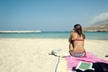 Young woman sitting on a beautiful beach Royalty Free Stock Photo