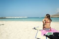 Young woman sitting on a beautiful beach Royalty Free Stock Photo