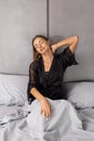 Young woman sitting in bed suffering from neck pain Royalty Free Stock Photo