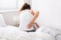 Woman Sitting On Bed Having Back Pain Royalty Free Stock Photo