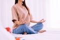 Young woman sitting on bed practicing doing yoga meditation,Workout exercise after waking up in morning,Healthy and lifestyle conc Royalty Free Stock Photo