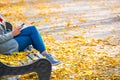 Young woman sitting on a bench in park Royalty Free Stock Photo