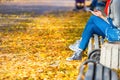 Young woman sitting on a bench in park Royalty Free Stock Photo