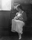Young woman sitting on a bench playing the mandolin