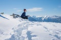 Young woman sitting on a bench in snowy landscape, Wank mountain summit Royalty Free Stock Photo