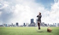 Young woman sitting on big light bulb Royalty Free Stock Photo