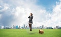 Young woman sitting on big light bulb Royalty Free Stock Photo