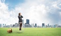 Young woman sitting on big light bulb Royalty Free Stock Photo