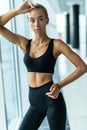 Young woman sitting on a box at gym after her workout. Caucasian female athlete taking rest after exercising at gym Royalty Free Stock Photo