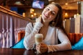 Young woman sitting in cafe Royalty Free Stock Photo