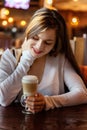 Young woman sitting in cafe Royalty Free Stock Photo