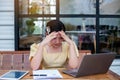 Young woman sitting in a cafe with her laptop, Stressful for work Royalty Free Stock Photo