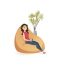 Young Woman Sitting Calm in Brown Beanbag Chair Royalty Free Stock Photo