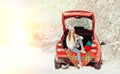 Young woman are sitting in a car in the winter forest and drink coffee. Sun flare as art photography Royalty Free Stock Photo