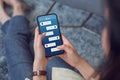 Young woman sitting on carpet and hand holding smartphone and show screen new chat messages notification. Concept social network. Royalty Free Stock Photo