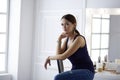 Young woman sitting on a chair isolated over white background Royalty Free Stock Photo