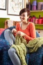 Young Woman Sitting In Chair Knitting