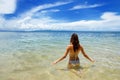 Young woman sitting in clear water on Taveuni Island, Fiji