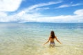 Young woman sitting in clear water on Taveuni Island, Fiji