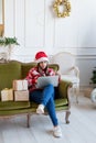 Young woman sitting on couch in a decorated living room working on laptop computer Royalty Free Stock Photo