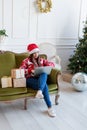 Young woman sitting on couch in a decorated living room working on laptop computer Royalty Free Stock Photo