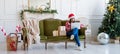 Young woman sitting on couch in a decorated living room working on laptop computer Royalty Free Stock Photo