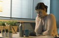 Young woman sitting at desk and using her laptop Royalty Free Stock Photo