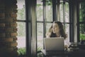 Young woman sitting at desk working with laptop computer at home Royalty Free Stock Photo