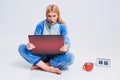 Young woman sitting on the floor in his pajamas with a laptop. Royalty Free Stock Photo
