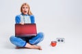 Young woman sitting on the floor in his pajamas with a laptop. Royalty Free Stock Photo