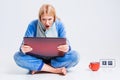 Young woman sitting on the floor in his pajamas with a laptop. Royalty Free Stock Photo