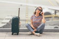 Young woman sitting on the floor in waiting hall in airport of Eindhoven Royalty Free Stock Photo