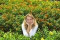 Young woman sitting in flowers Royalty Free Stock Photo
