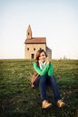 Young woman is sitting in front of the church Royalty Free Stock Photo