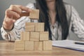 young woman sitting in front of a pyramid of cubes